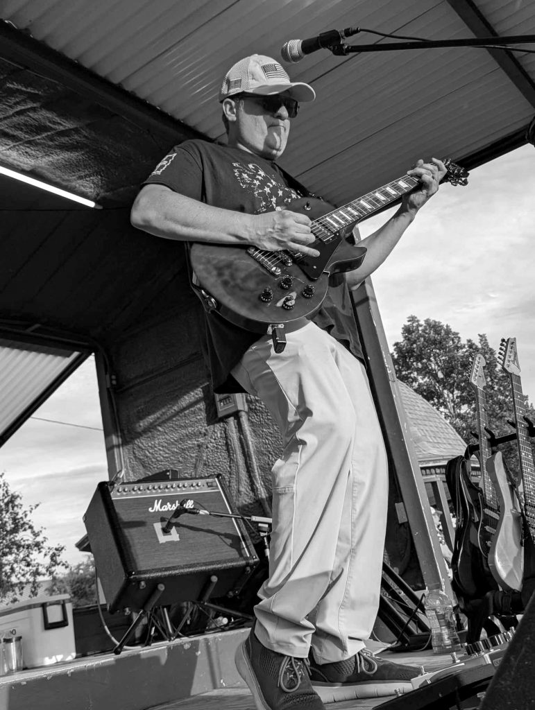 Edgar Santana playing guitar live at a show.